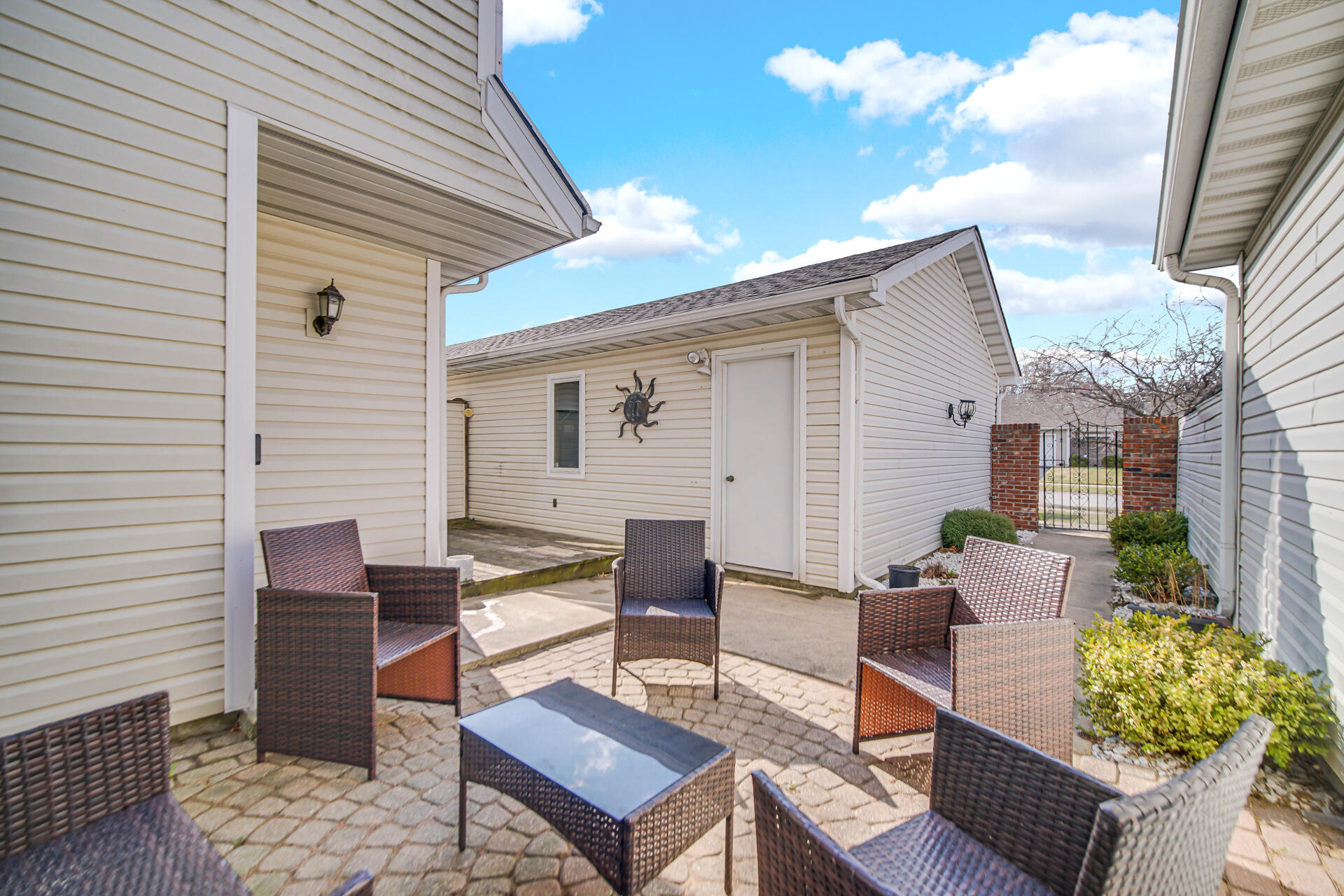 9993 Hunters Run St. John, IN 46373 - Photo 6 of 28 a outdoor space with patio the couches and a potted plant on the table