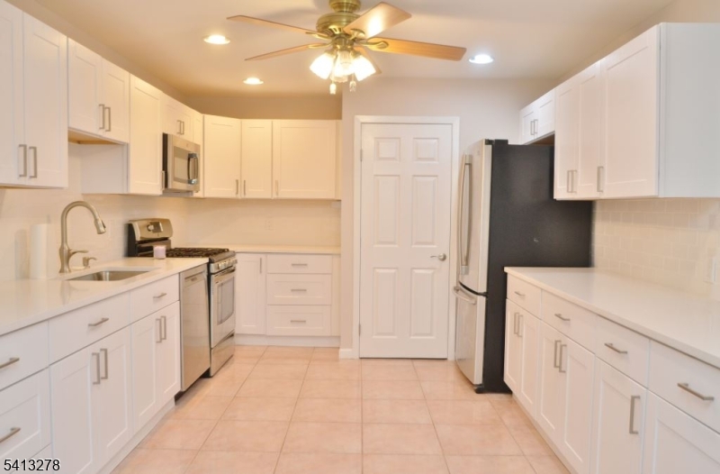 13 Gracie Road East Hanover, NJ 07936 - Photo 2 of 15 a kitchen with white cabinets and refrigerator