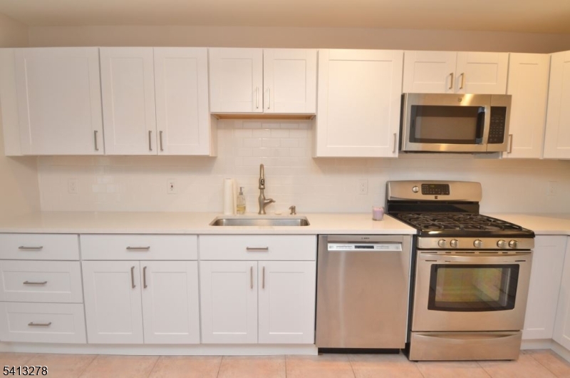 13 Gracie Road East Hanover, NJ 07936 - Photo 4 of 15 a kitchen with white cabinets and appliances