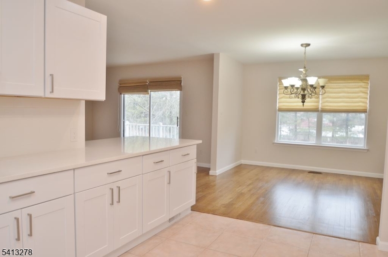 13 Gracie Road East Hanover, NJ 07936 - Photo 5 of 15 an empty room with chandelier fan and windows