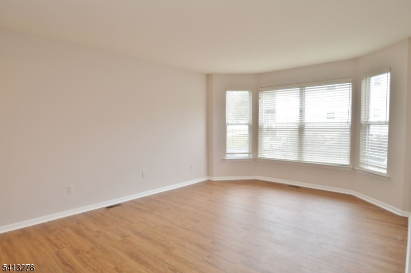 13 Gracie Road East Hanover, NJ 07936 - Photo 9 of 15 an empty room with wooden floor and windows