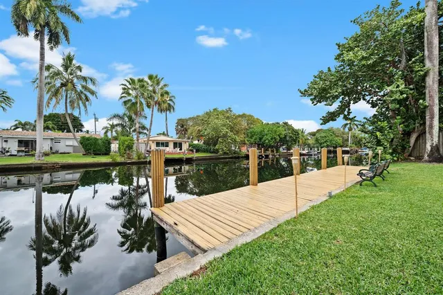 a view of a lake with a table and chairs in the patio