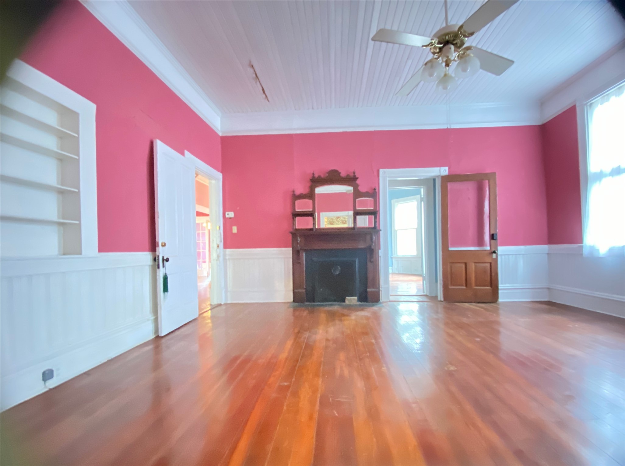223 East Robert Toombs Avenue Washington, GA 30673 - Photo 16 of 46 a view of a livingroom with wooden floor a ceiling fan and windows