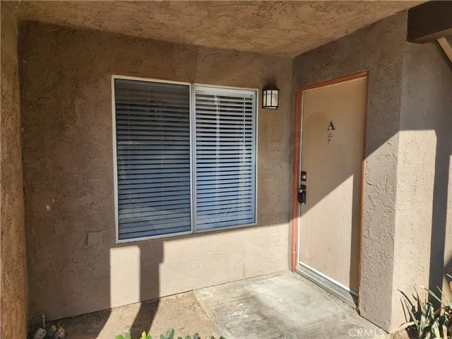 a kitchen with granite countertop a stove a sink and a refrigerator