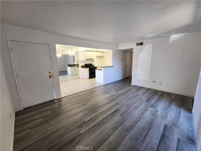 an empty room with wooden floor and closet