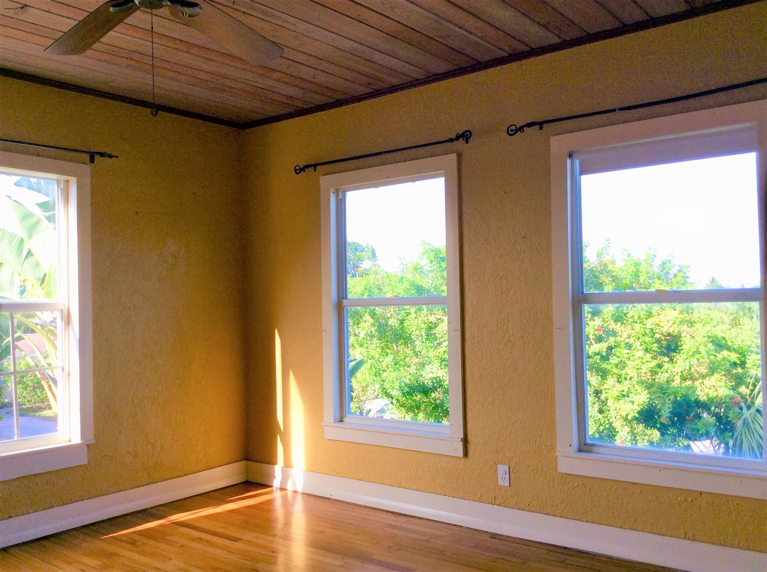 382 Ellamar Road West Palm Beach, FL 33405 - Photo 22 of 39 a view of empty room with wooden floor and fan