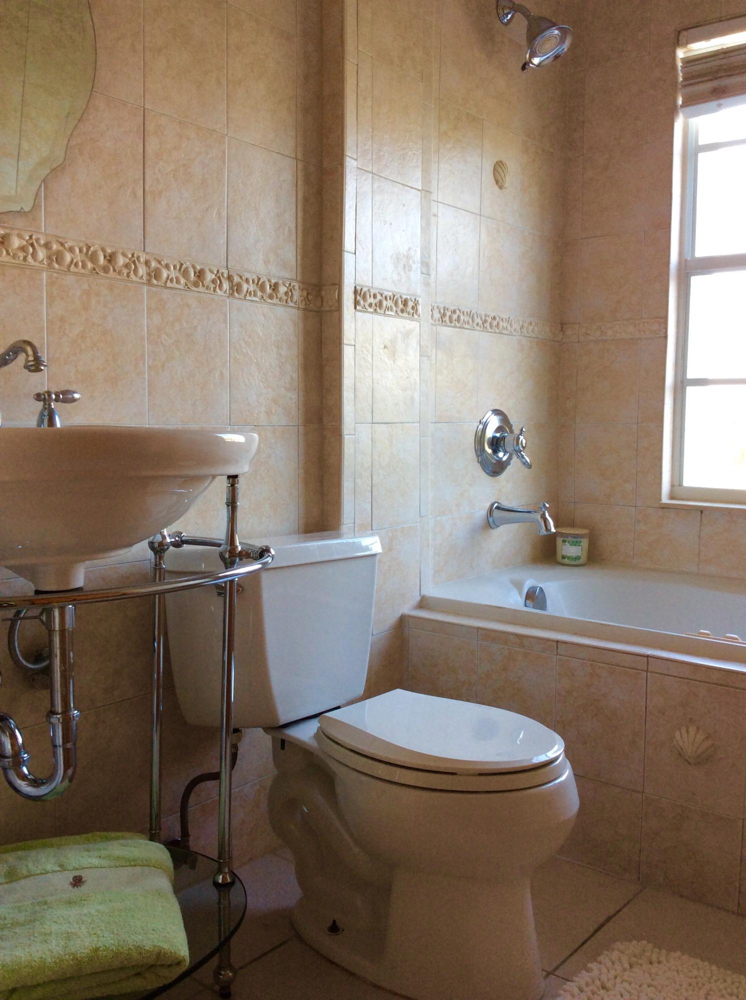 382 Ellamar Road West Palm Beach, FL 33405 - Photo 28 of 39 a bathroom with a sink a toilet and tub