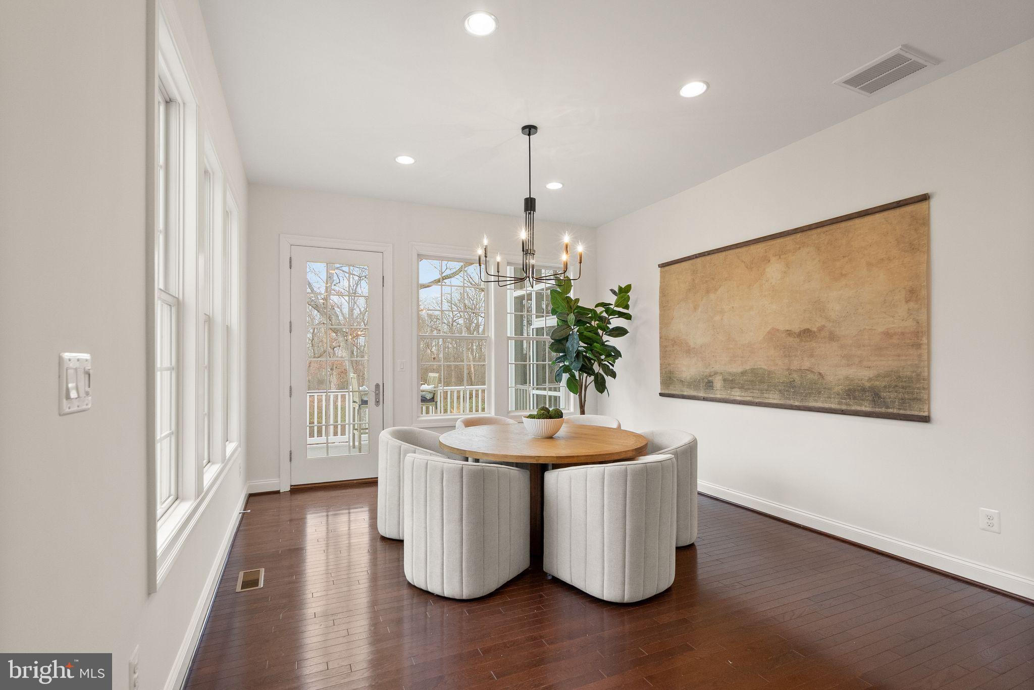 24974 First Harvest Court Aldie, VA 20105 - Photo 33 of 143 a dining room with chandelier and wooden floor