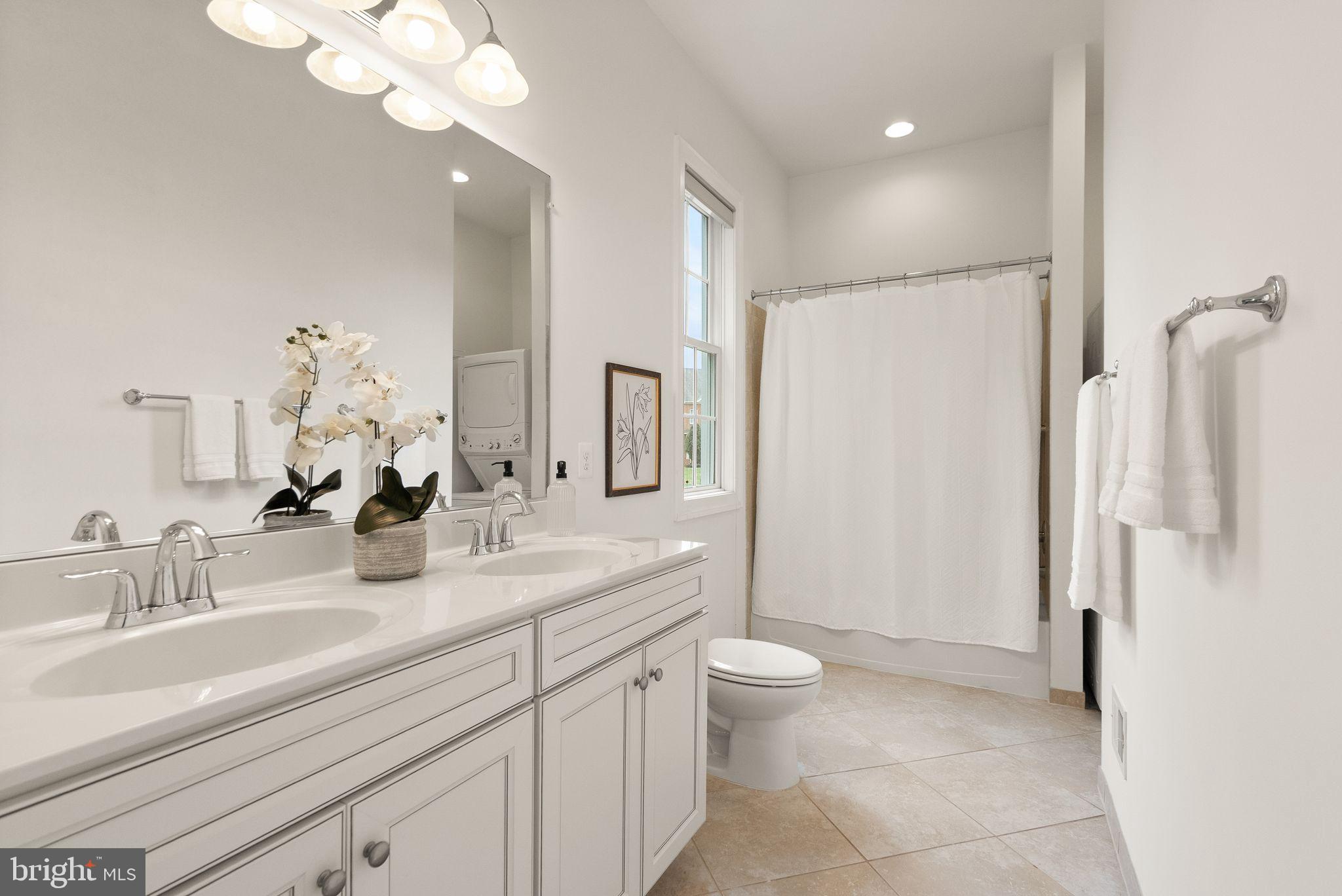 24974 First Harvest Court Aldie, VA 20105 - Photo 49 of 143 a bathroom with a double vanity sink a toilet and a mirror