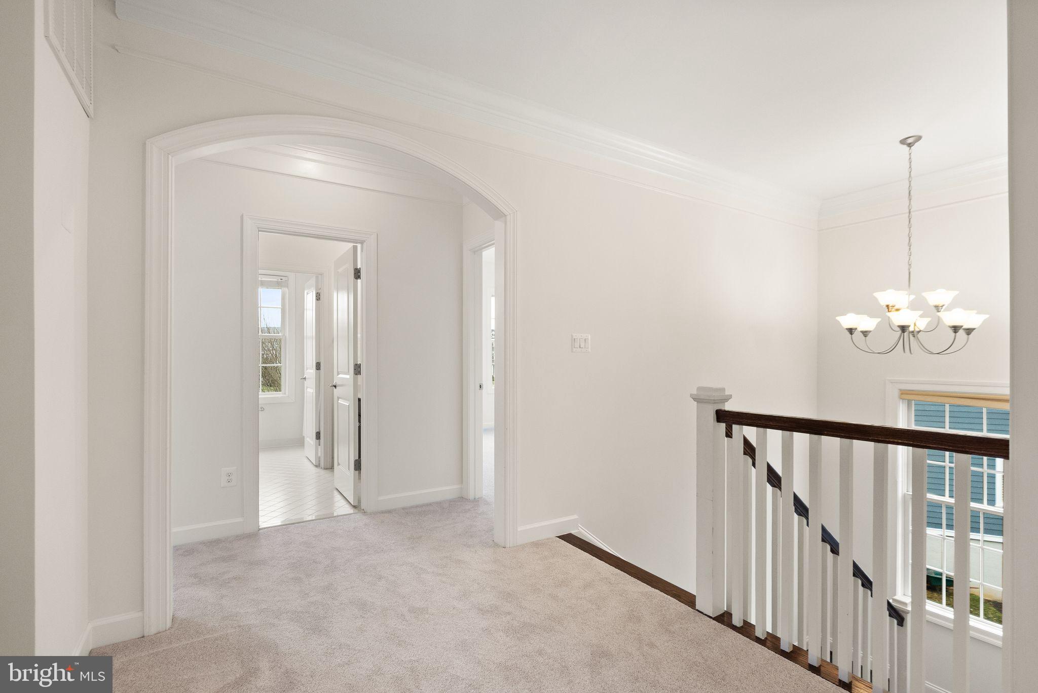 24974 First Harvest Court Aldie, VA 20105 - Photo 57 of 143 a view of a hallway with wooden floor and staircase