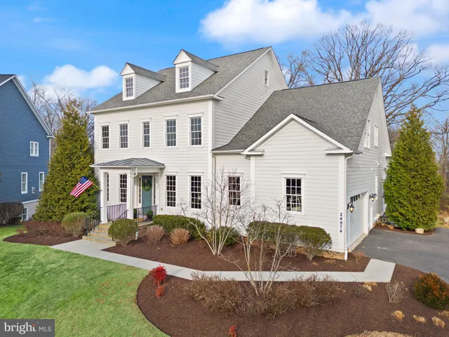 a living room with furniture kitchen view and a large window