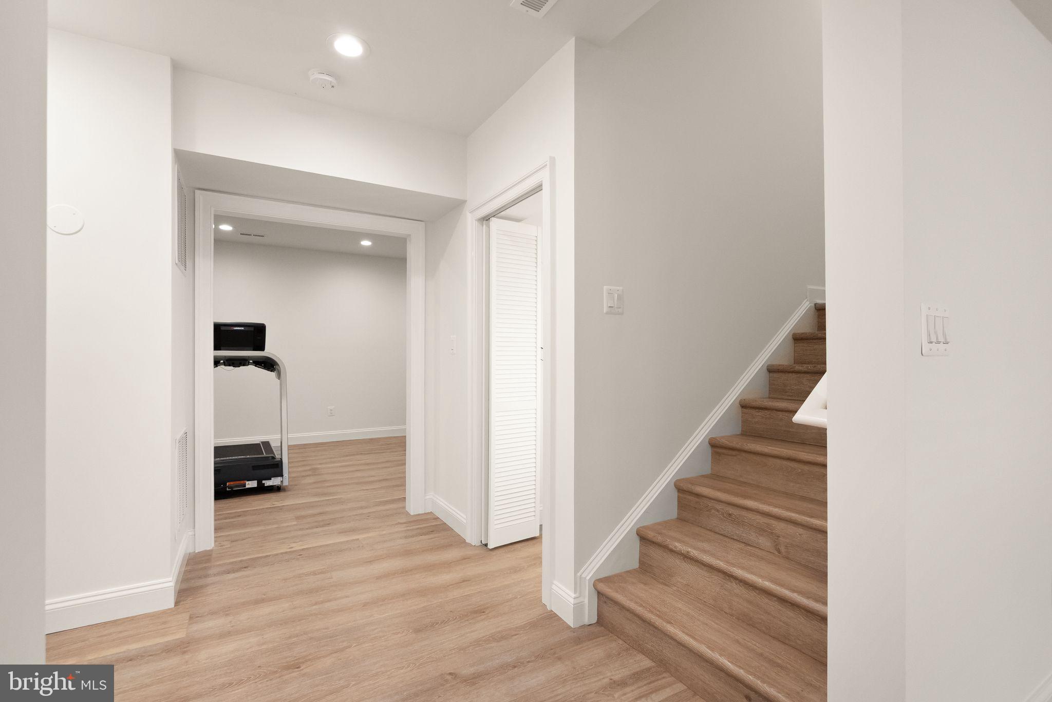 24974 First Harvest Court Aldie, VA 20105 - Photo 87 of 143 a view of a hallway with wooden floor and staircase