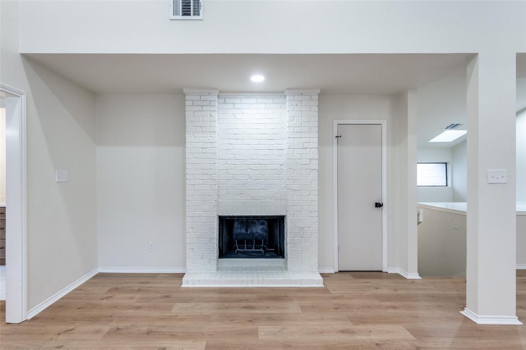17490 Meandering Way, Unit 2202 Dallas, TX 75252 - Photo 4 of 24 Living area featuring a painted brick fireplace, wood-finish flooring, recessed lighting, and high ceilings