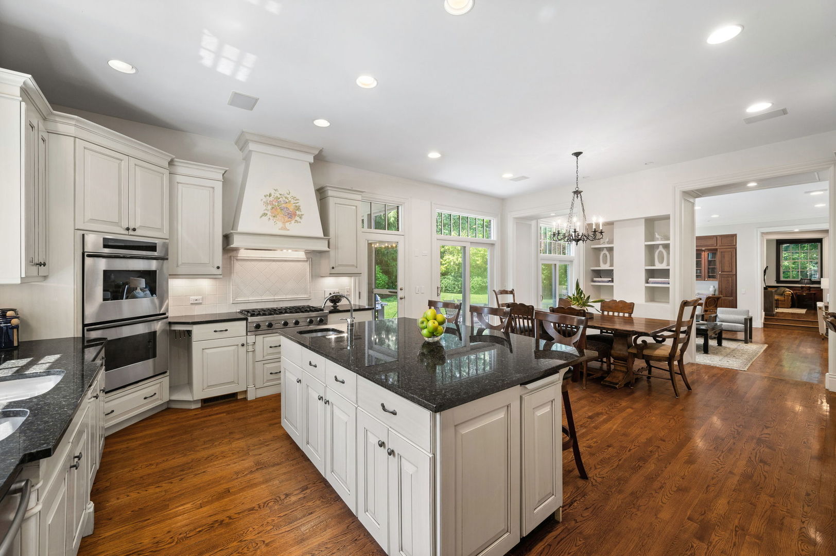 228 Old Green Bay Road Glencoe, IL 60093 - Photo 13 of 40 a kitchen with stainless steel appliances kitchen island granite countertop a stove a sink a refrigerator and white cabinets with wooden floor