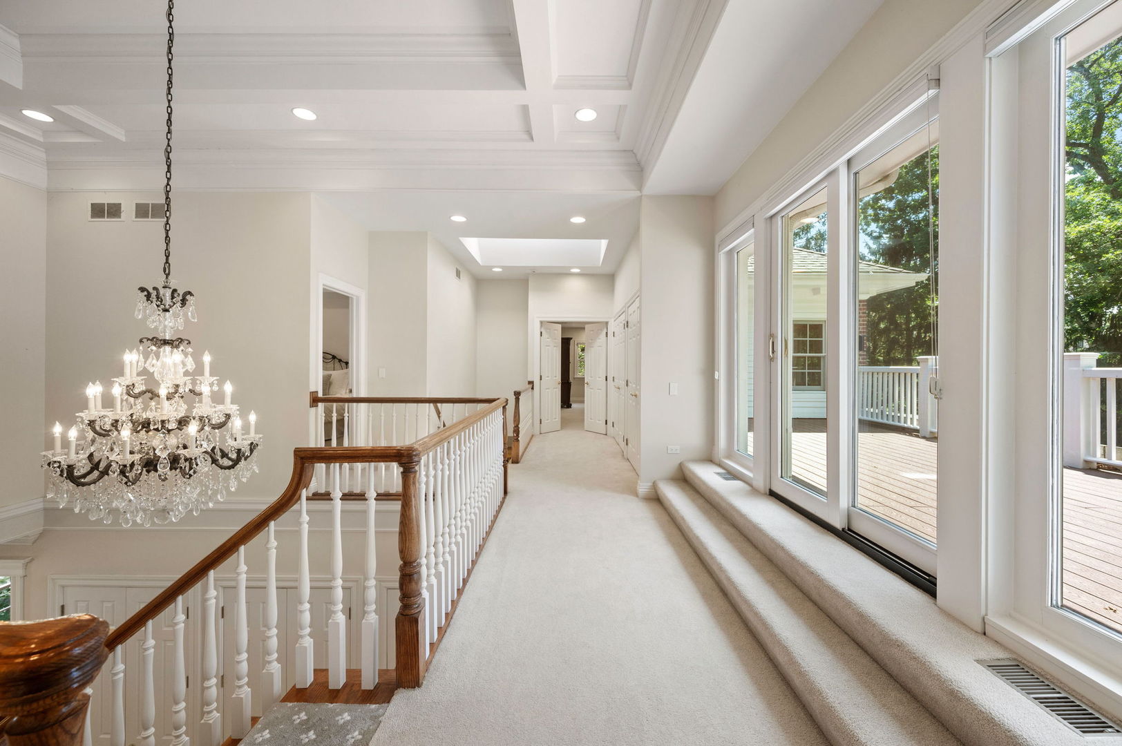 228 Old Green Bay Road Glencoe, IL 60093 - Photo 18 of 40 a view of a hallway with wooden floor and windows