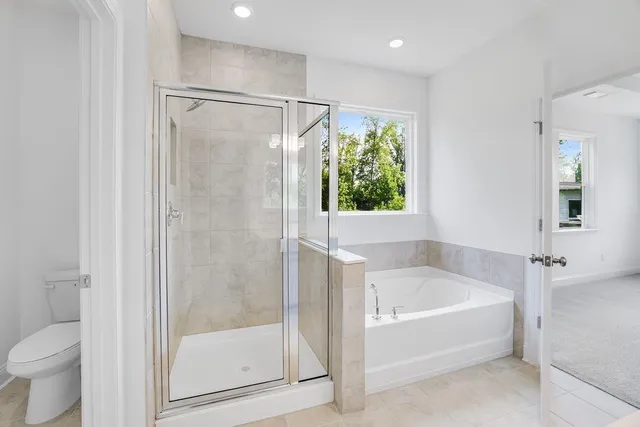 a white bath tub sitting next to a toilet