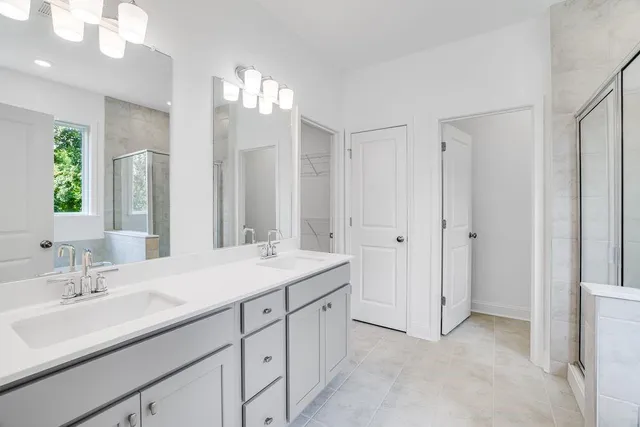a en suite bathroom with double sink and a mirror