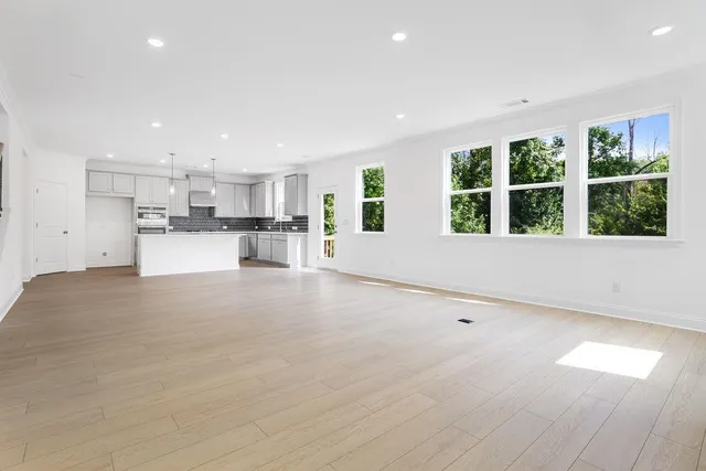 a large white kitchen with a large window