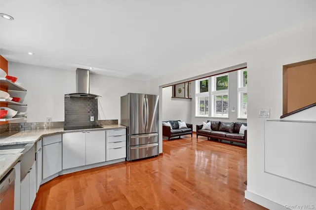 a kitchen with stainless steel appliances a stove a sink and a refrigerator