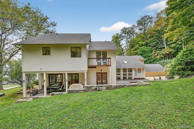 a view of a lush green field with mountains in the background