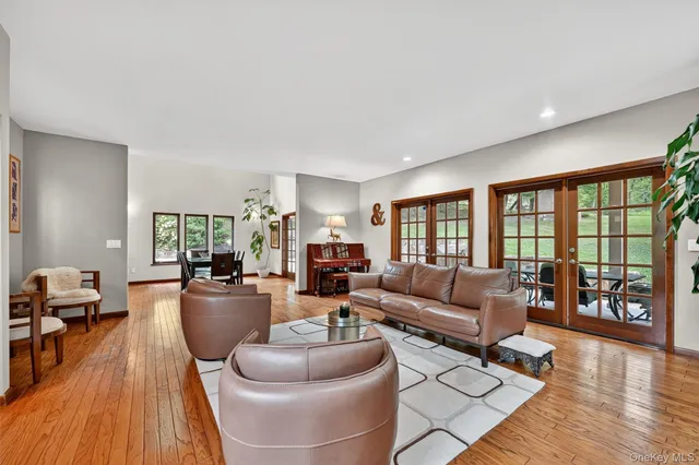 a living room with furniture flowerpot and wooden floor