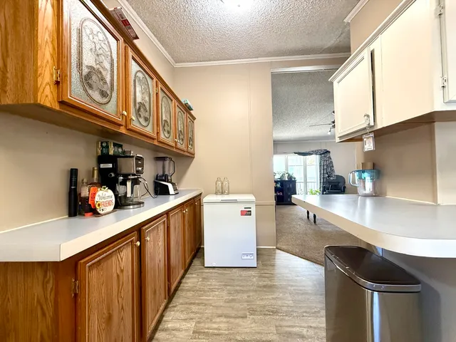 a kitchen with stainless steel appliances granite countertop a lot of cabinets