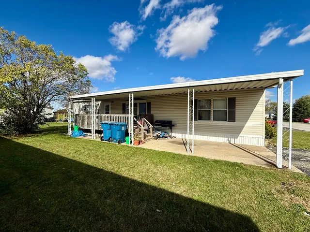 a view of a house with a backyard porch and sitting area