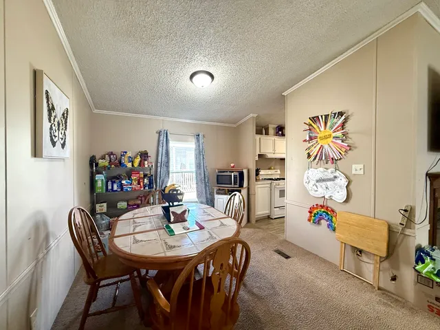 a view of a livingroom with furniture and a dining table