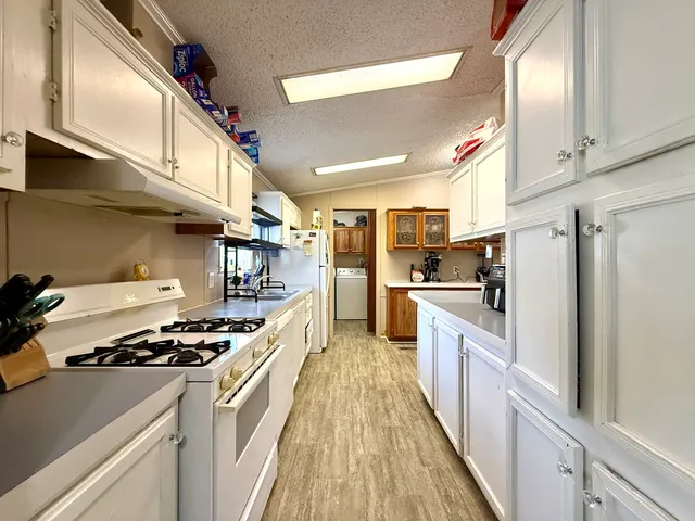 a kitchen with stainless steel appliances a refrigerator a stove and a sink