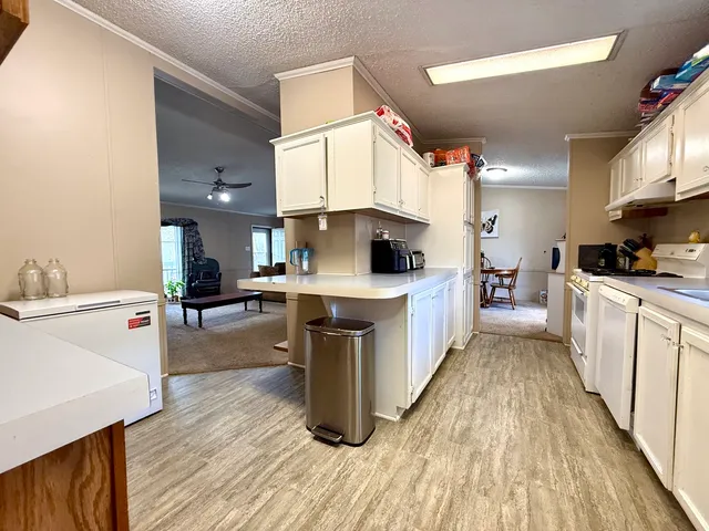 a large white kitchen with a lot of counter space