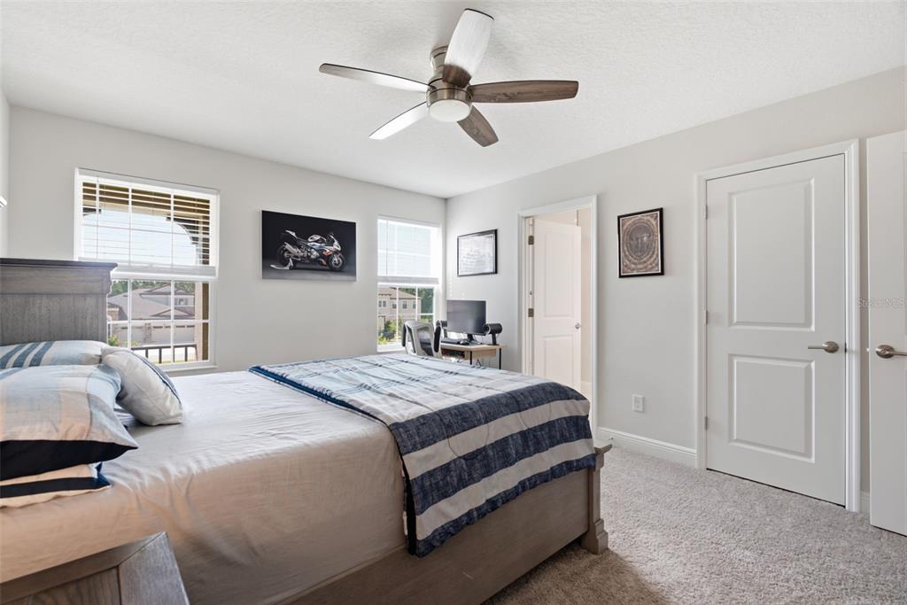 12970 Steed Trce Loop Lithia, FL 33547 - Photo 38 of 57 a bedroom with a bed and a chandelier