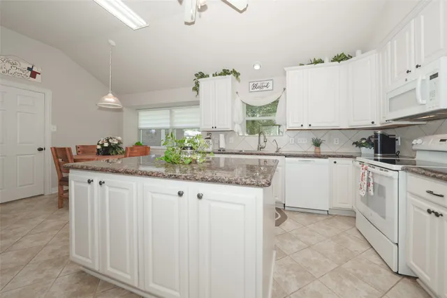 a kitchen with stainless steel appliances granite countertop a sink and cabinets