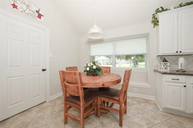 a dining room with furniture and window
