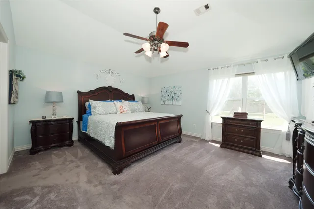 a bedroom with a bed and window