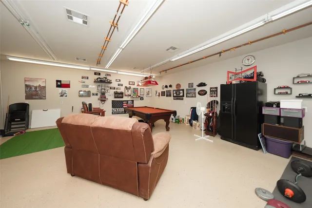 a living room with lots of furniture and clutter