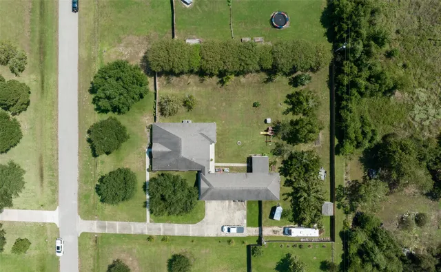 aerial view of a house with a yard