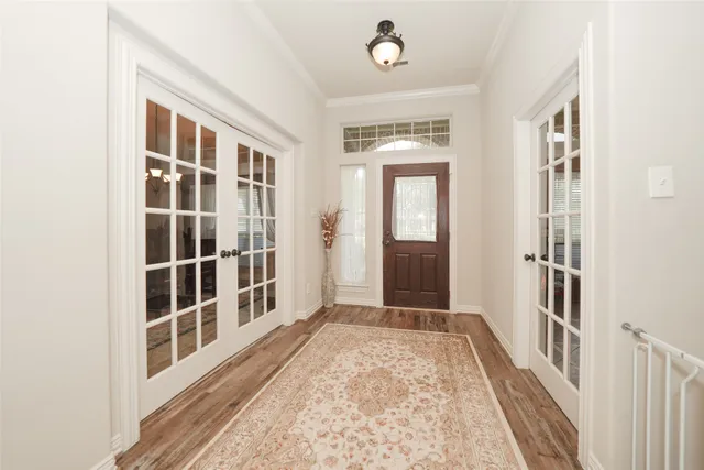 a view of a hallway with wooden floor and windows