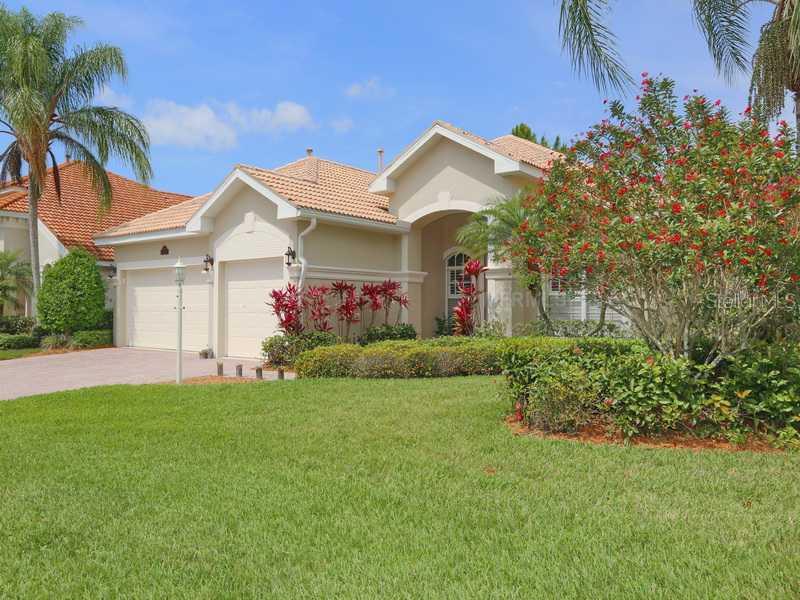 7708 US Open Loop Lakewood Ranch, FL 34202 - Photo 1 of 1 a front view of a house with a garden