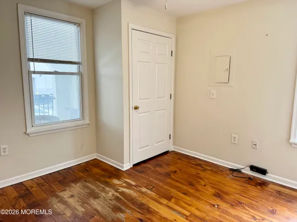 a view of a room with wooden floor and closet