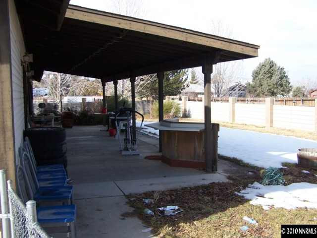 15385 Bonanza Lane Reno, NV 89521 - Photo 4 of 4 a view of a patio with table and chairs potted plants with wooden floor