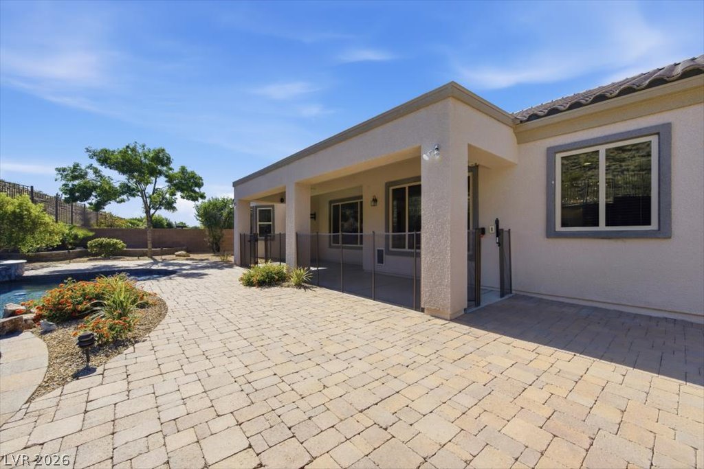 2125 De Rouge Avenue Henderson, NV 89044 - Photo 71 of 96 A spacious paver patio and covered outdoor area provide ample space for relaxation and entertainment.