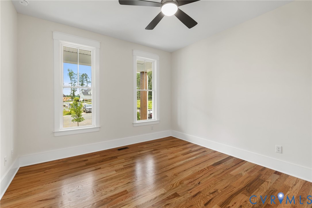 3525 Ampfield Way Midlothian, VA 23112 - Photo 3 of 35 a view of an empty room with wooden floor and window