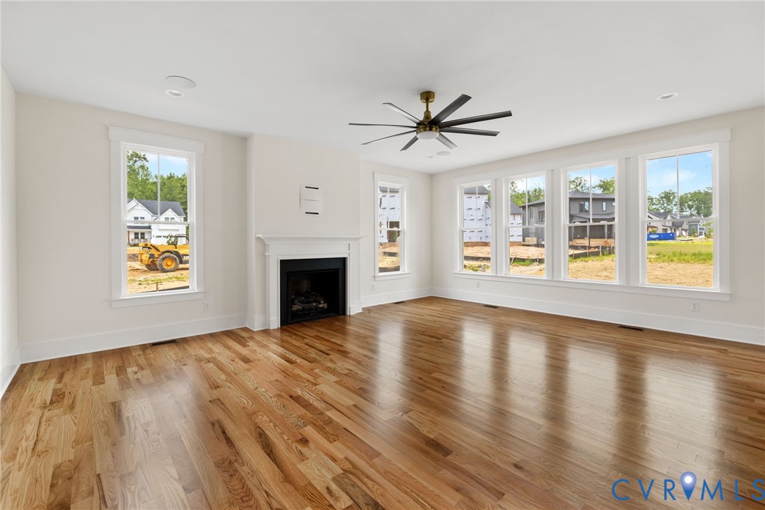 3525 Ampfield Way Midlothian, VA 23112 - Photo 5 of 35 a view of an empty room with a window and wooden floor