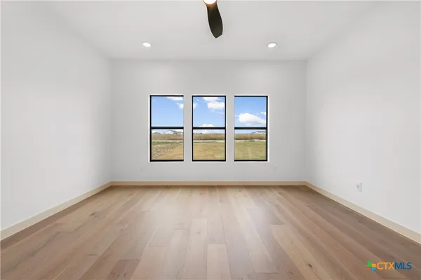 a bathroom with a double vanity sink mirror and bathtub