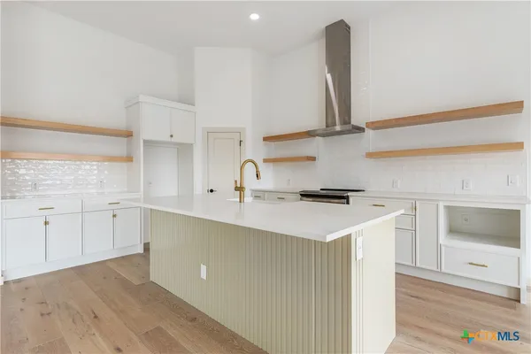 a kitchen with a sink stove and cabinets