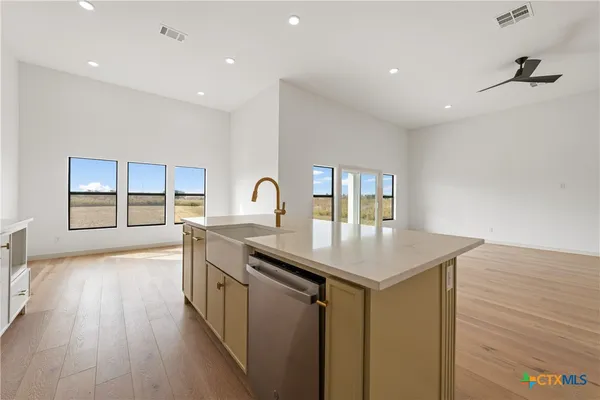 a kitchen with granite countertop a stove and a sink