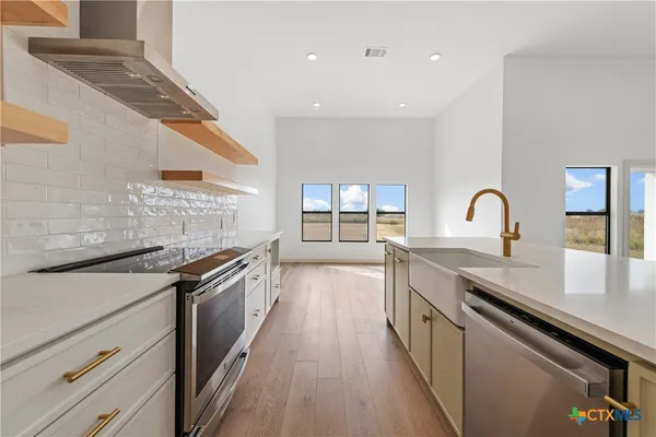 a stove top oven sitting inside of a kitchen