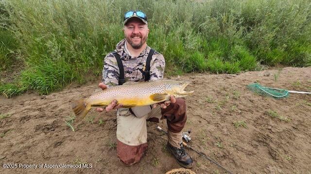 1989 County Road 320 Rifle, CO 81650 - Photo 1 of 36 a wooden bench sitting in the middle of a backyard