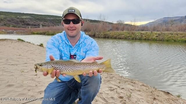 a view of a wooden floor with a table and chairs in roof