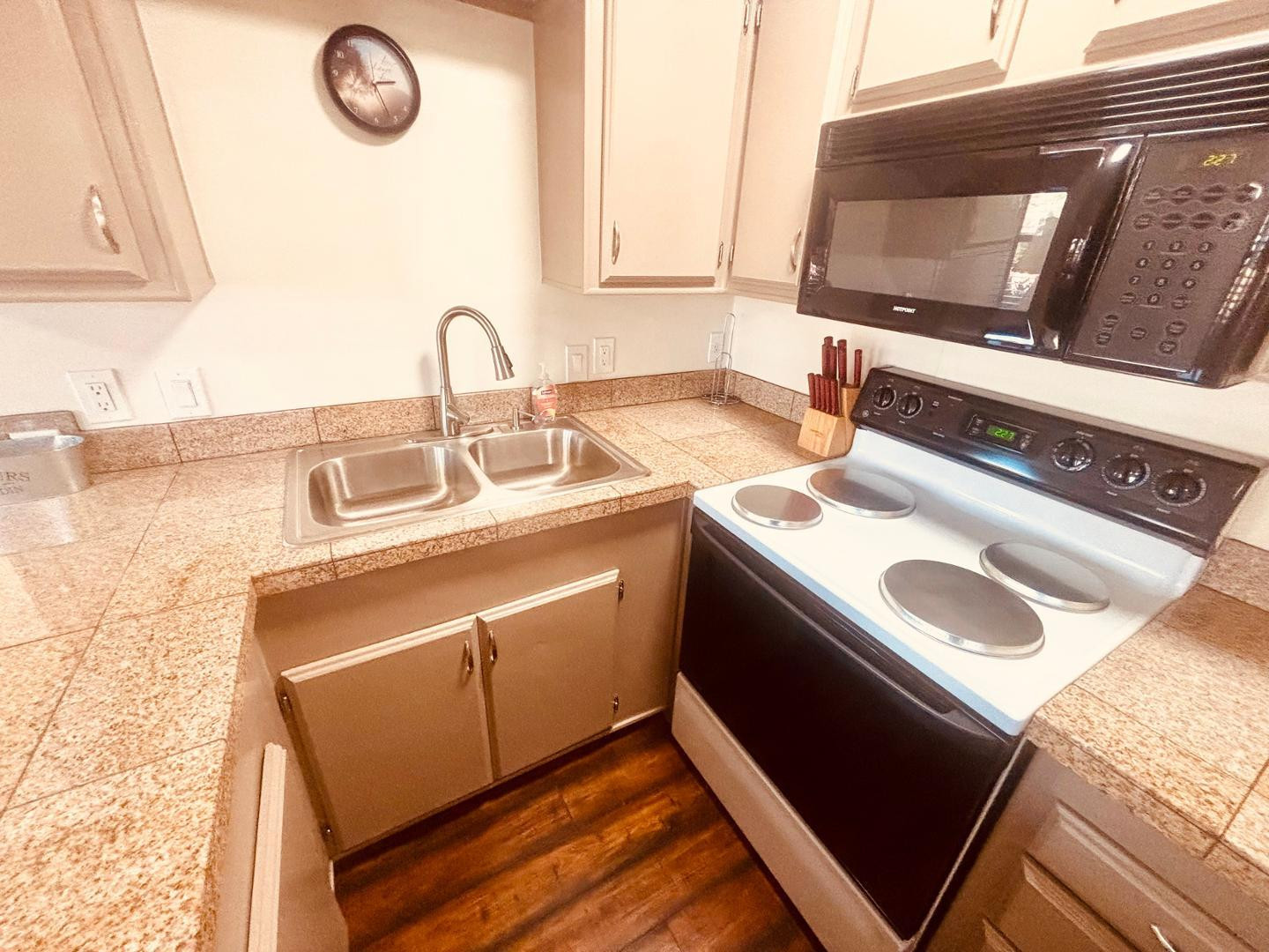 8865 East Baseline Road, Unit 405 Mesa, AZ 85209 - Photo 2 of 16 a close view of a sink and a stove sitting inside of a kitchen